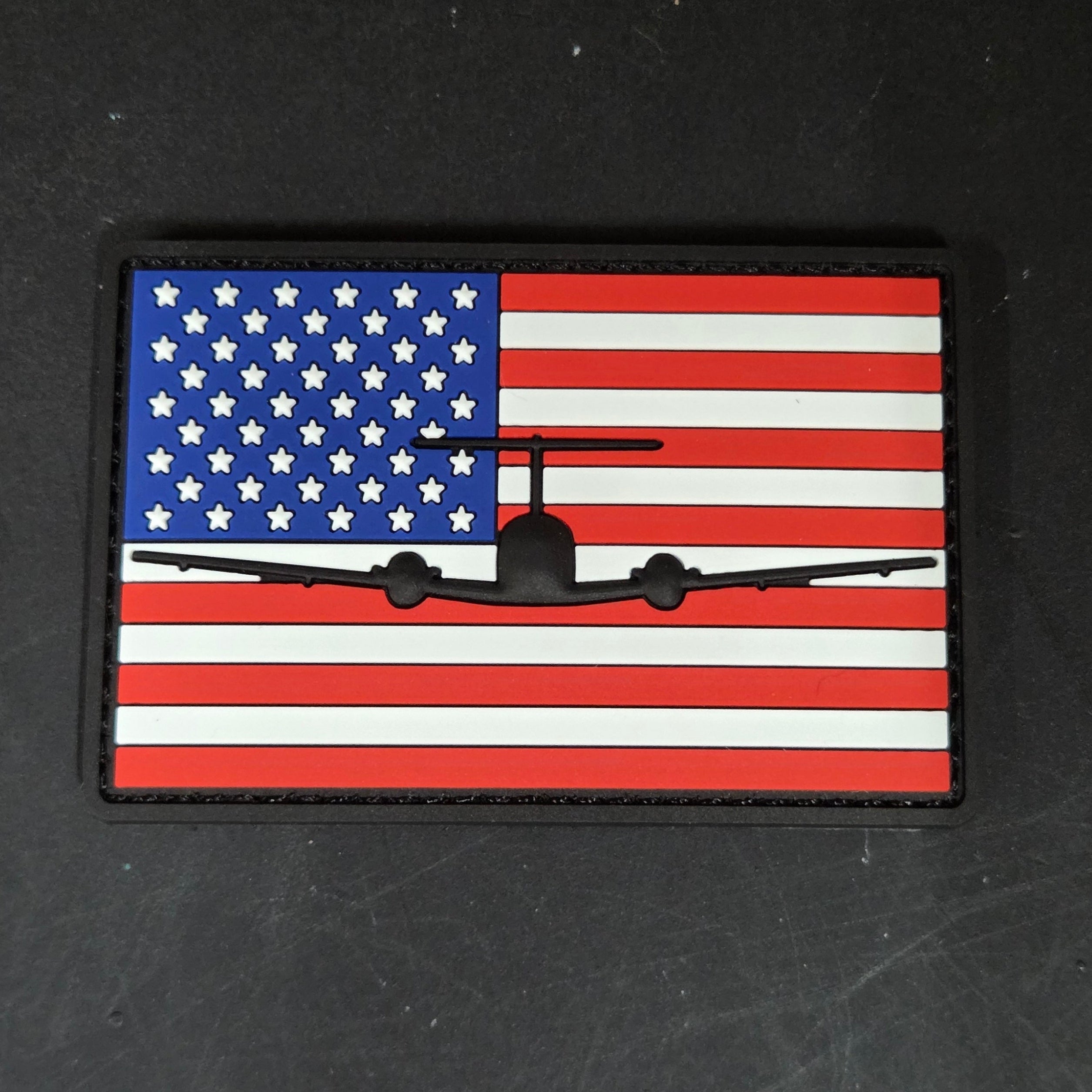 PVC patch with C-12 Huron American flag design on a black background
